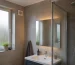 Modern European bathroom after showering with lingering condensation and a small conventional wall-mounted extractor fan